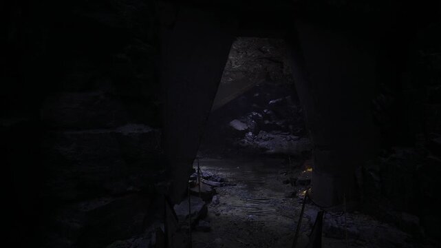 Research sampling site in cave setting, portable lamps illuminate sample bags and instruments, sensors placed in mossy niches, data collection atmosphere,