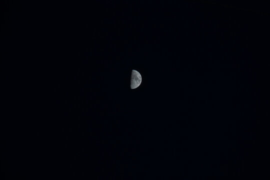 Crescent moon phase glowing in dark night sky
