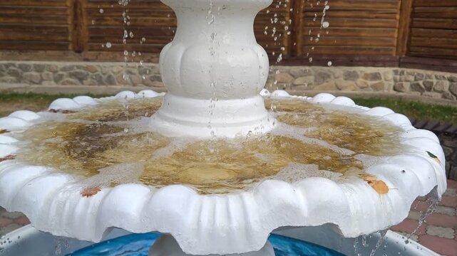 Close-up of an old fountain with falling water.