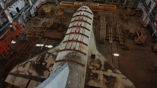 Aerial view of Baikonur Cosmodrome showing an abandoned space shuttle inside a large industrial hangar with metal equipment Karmakshy District, Kyzylorda Region, Kazakhstan.