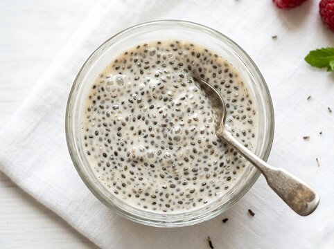 Healthy chia seed pudding in a glass bowl with a spoon