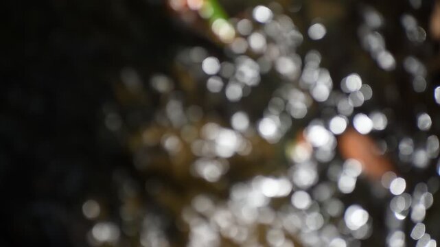 A dreamy view of water drops splashing and sparkling in the natural sun.