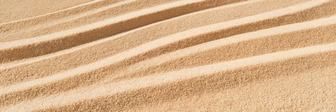 Abstract composition of rippled sand texture with diagonal lines and warm beige tones