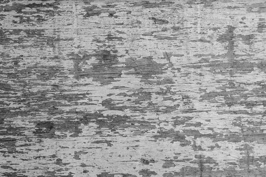 Close-up of an aged wooden surface with peeling paint, visible wood grain, scratches, and rough weathered texture, suitable for rustic backgrounds and vintage designs