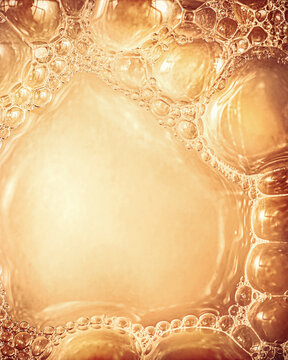 Abstract golden foam macro background with copy space frame