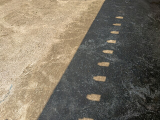 Obraz premium Wall Shadow Cast on Aged Concrete Floor Surface