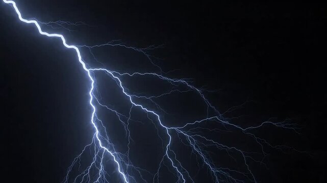 Bright lightning bolt flashing and branching across dark night sky