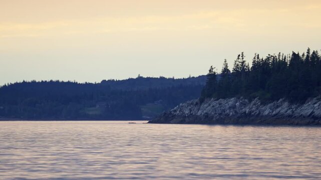 New River Beach Provincial Park sandy tidal shoreline under dramatic overcast twilight skies along the Bay of Fundy, New Brunswick.
