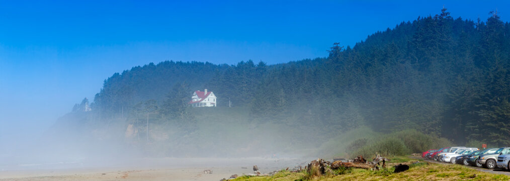 Beautiful wide panoramic view of a historic house on a forested mountain in morning fog