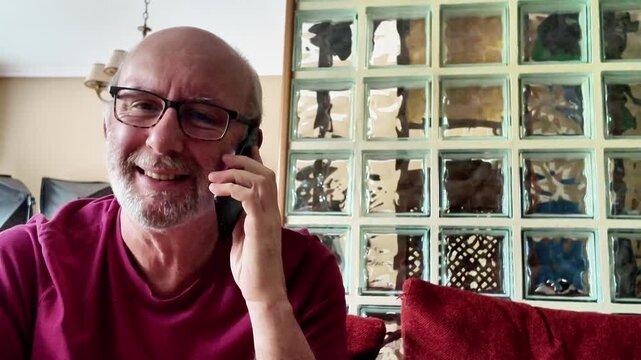 Man talking on smartphone at home