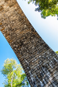 View from under a stone bridge with the blue sky in the background 