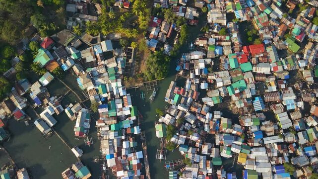 Drone footage over Coron Town on Busuanga Island, Palawan, revealing the colorful coastal settlement, fishing boats, waterfront homes and tropical landscape of this popular Philippine destination.