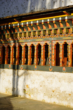 Changangkha Lhakhang, Traditional colorful wooden carved window detail on textured whitewashed wall