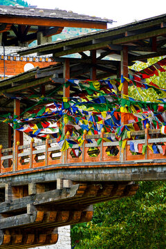 Changjiji Traditional Bridge, Traditional Asian wooden pavilion decorated with colorful prayer flags in nature