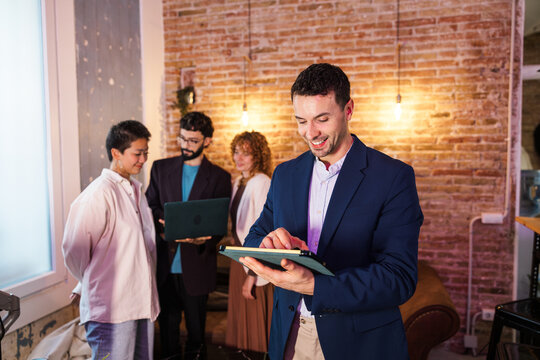 Manager using digital tablet leading business meeting in startup office