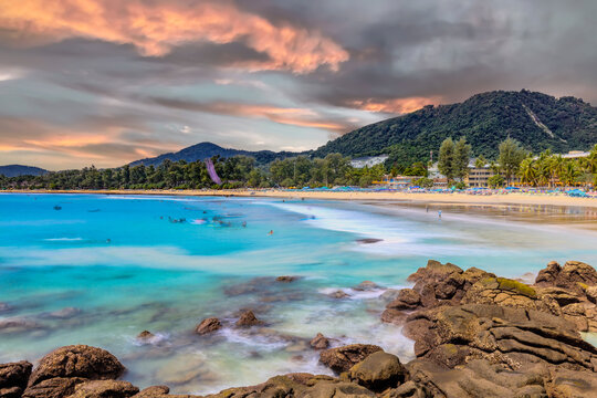Long Exposure Seascape of Kata Beach with Rocky Shoreline and Tropical Forest, Phuket, Thailand
