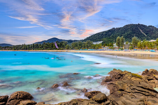 Long Exposure Seascape of Kata Beach with Rocky Shoreline and Tropical Forest, Phuket, Thailand
