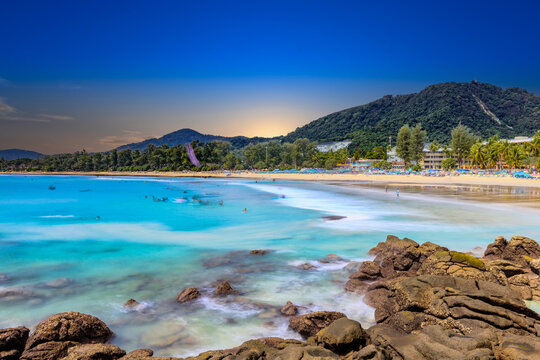 Long Exposure Seascape of Kata Beach with Rocky Shoreline and Tropical Forest, Phuket, Thailand
