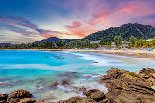 Long Exposure Seascape of Kata Beach with Rocky Shoreline and Tropical Forest, Phuket, Thailand