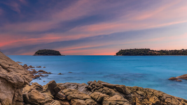 Long Exposure Seascape of Kata Beach with Rocky Shoreline and Tropical Forest, Phuket, Thailand