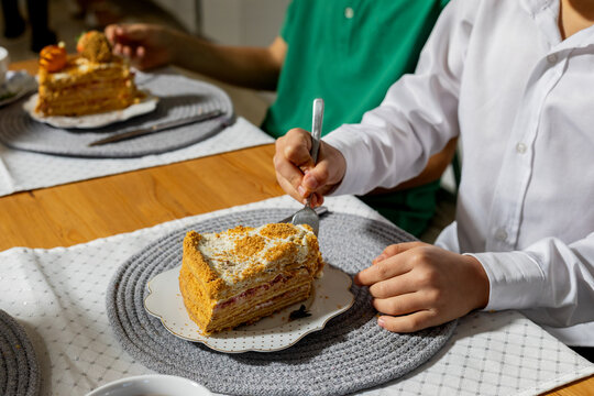 Family celebration with layered cake slices at dining table
