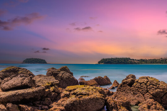 Long Exposure Seascape of Kata Beach with Rocky Shoreline and Tropical Forest, Phuket, Thailand