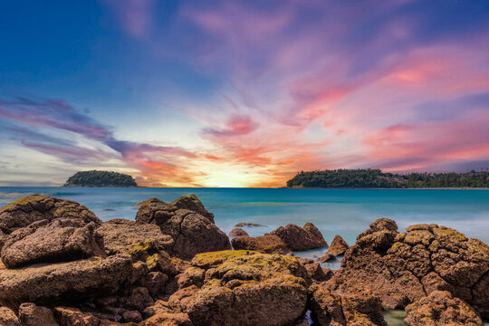 Long Exposure Seascape of Kata Beach with Rocky Shoreline and Tropical Forest, Phuket, Thailand
