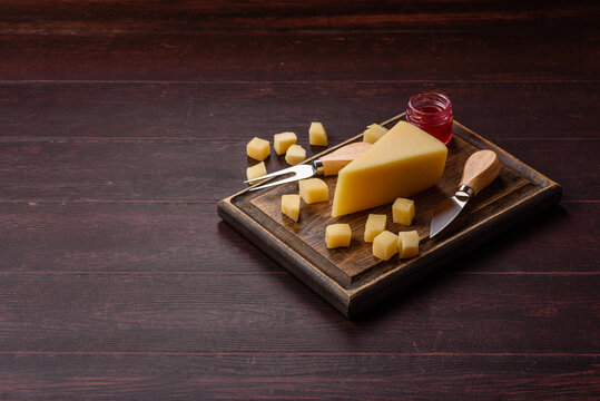 Hard aged Parmesan cheese in blocks and cubes for home cooking. Parmesan cheese