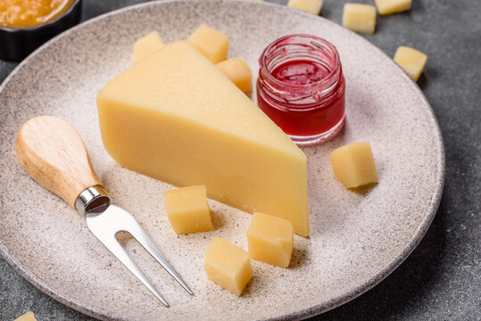 Hard aged Parmesan cheese in blocks and cubes for home cooking. Parmesan cheese