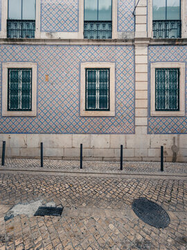 Traditional azulejo facade and cobblestone street in Lisboa