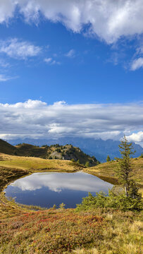 Alpine mountain pond beneath clouds in Dorfgastein, austria