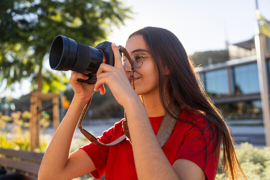 Woman photographer take picture outdoors with camera