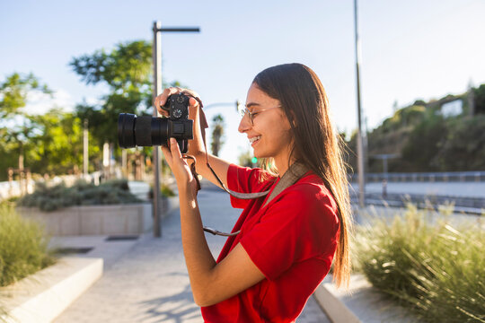 Woman photographer capture urban lifestyle in sunlight
