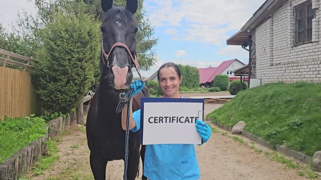 Person holding a certificate with a horse in a farm setting during the day