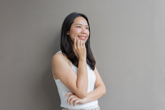 close up beautiful asian woman smile and beauty teeth and happy feeling on gray color background for veneer and invisalign treatment concept