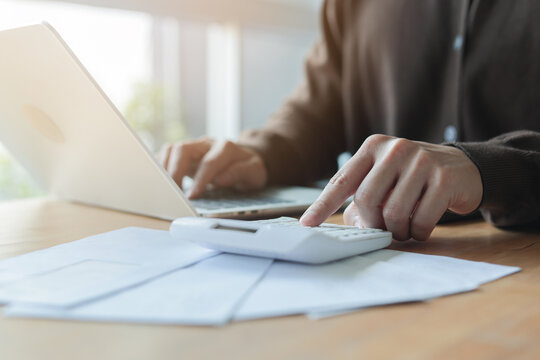 close up on man hand pressing on calculator for calculating cost estimating , senior accountant job working concept