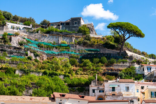 Facades of famous town of Amalfi, located on the Amalfi Coast, with its azure sea and beautiful colorful cliffside houses.