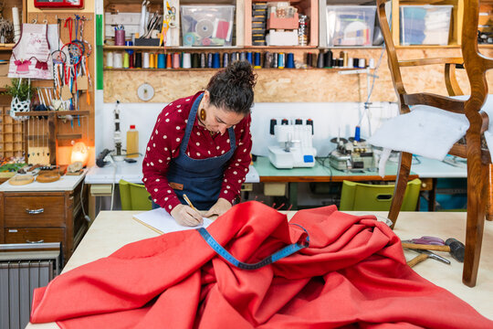 Artisan woman sketching for upholstery fabric cutting