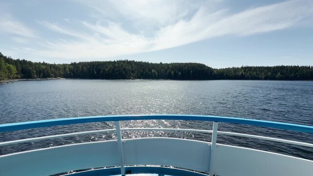 A cruise ship sails forward on Valaam, Lake Ladoga. This exciting journey evokes a peaceful, relaxing, and happy feeling.
