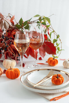 Elegant Thanksgiving Table Setting with Wine and Pumpkins Autumn Foliage Decoration