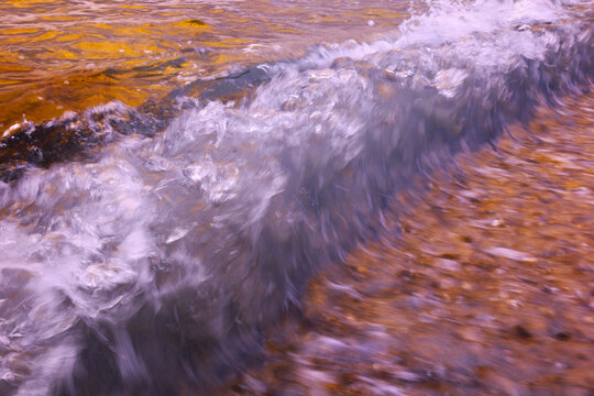 Abstract sea wave at Helgoland dune beach in sunset light