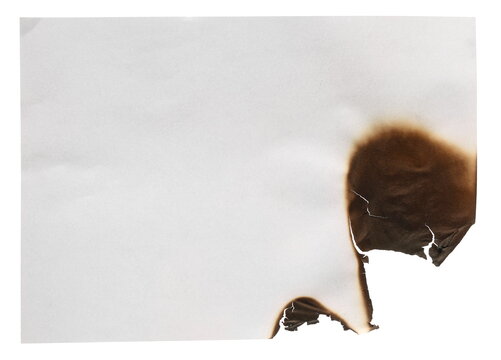 Burnt hole in paper sheet isolated on white background