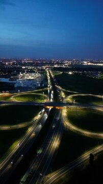 Illuminated Highway Interchange at Night: A breathtaking aerial view of a complex highway interchange illuminated by a myriad of lights.