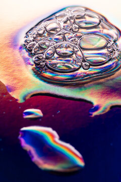 Iridescent water droplet macro with rainbow light refraction