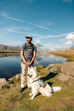 Hiker with white dog at Five Lakes near Zermatt