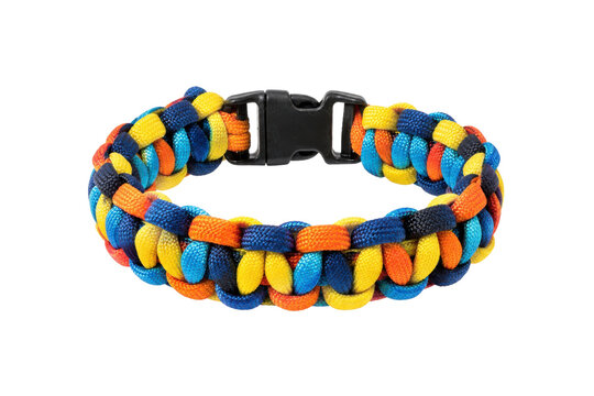 Vibrant colorful paracord survival bracelet with a black plastic buckle, photographed against a clean white background with bright studio lighting