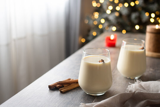 Festive eggnog with cinnamon and Christmas light bokeh