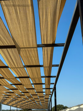 Fabric canopy on pergola structure against clear blue sky