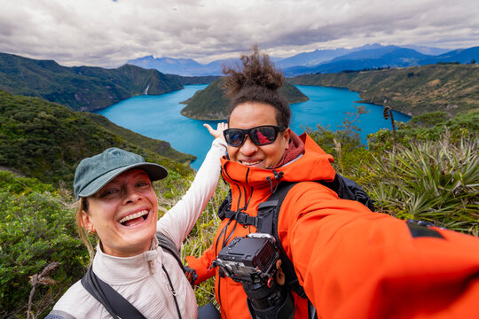 Hikers take selfie above Cuicocha lake in Ecuador