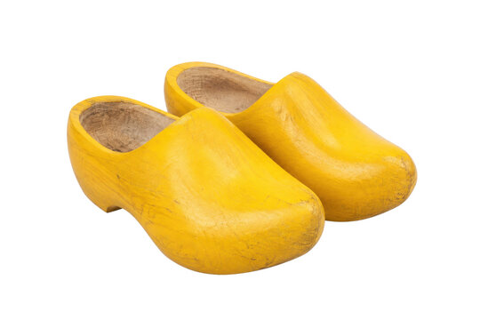 Pair of traditional yellow wooden clogs, also known as Dutch klompen, isolated on a clean white background